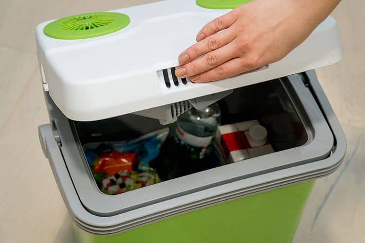 green portable refrigerator with drinks